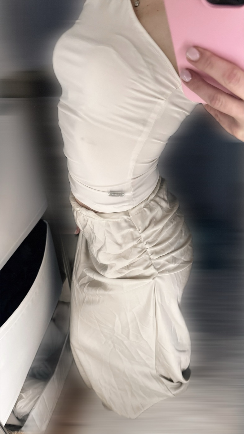 Close-up of a cream ruched skirt and fitted top