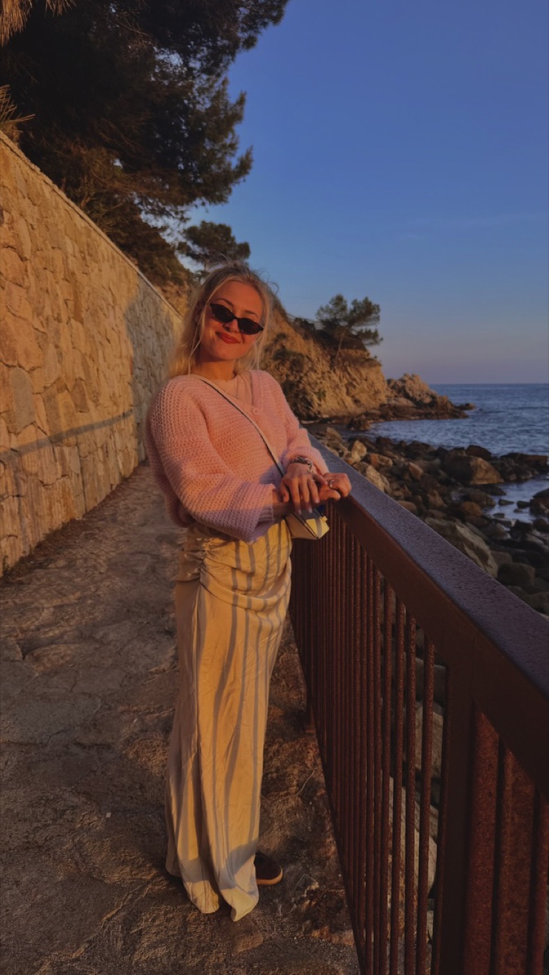 Striped skirt made by me, worn by the sea with a pink sweater that is not mine