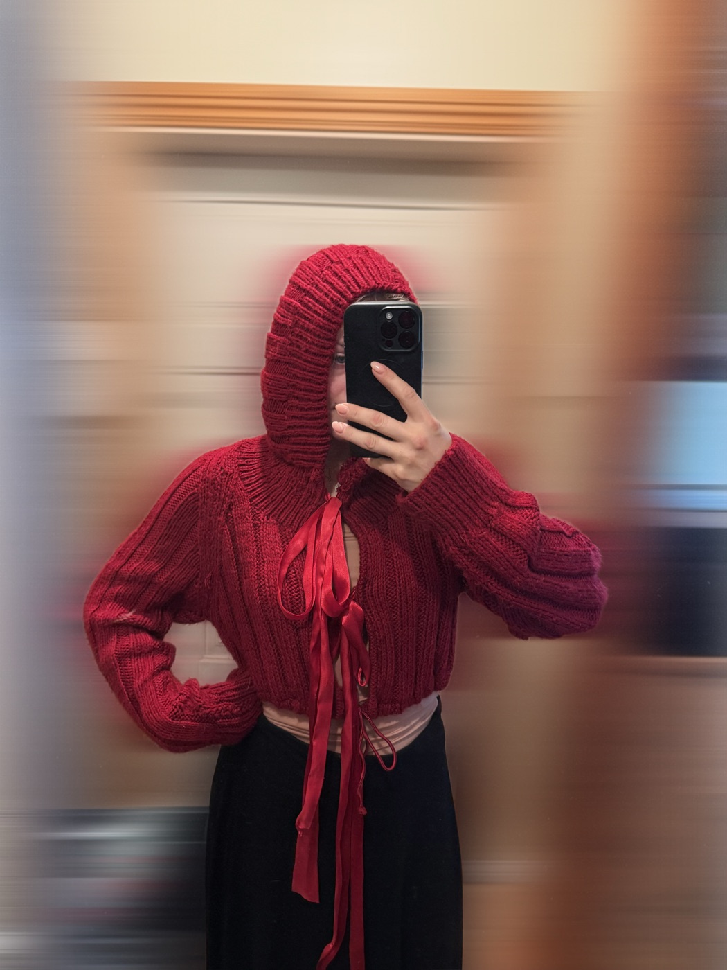 Red hooded knit with ribbon ties, hood up