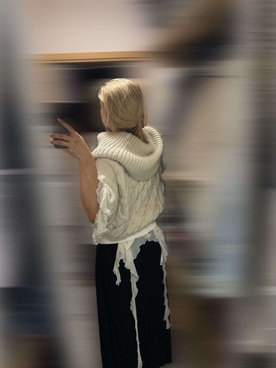 White knit shrug with frayed ties, seen from the back
